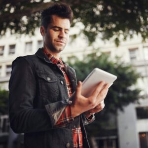 man using tablet in urban setting