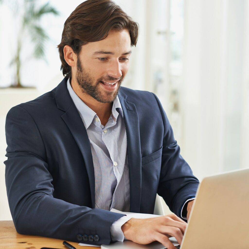 Work is a breeze today. A handsome businessman working on his laptop.